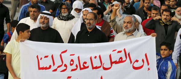 Protesters holding a banner saying Death is normal to us and our dignity from God is martyrdom take part in a protest against the execution of Saudi Shi'ite cleric Nimr al-Nimr by Saudi authorities, in the village of Sanabis, west of Manama, Bahrain January 2, 2016 - Sputnik International