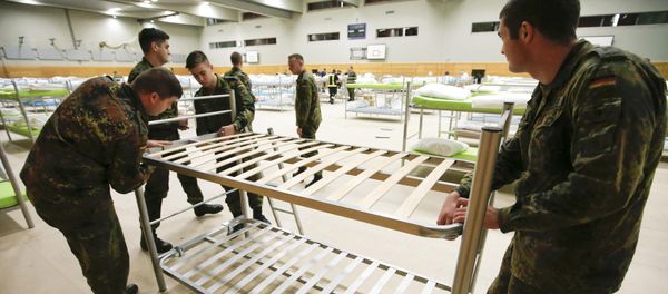 Soldiers from the guards battalion of the German armed forces Bundeswehr prepare beds as they transform the sports hall of the Jane-Addams high school into a refugee shelter in Hohenschoenhausen district in Berlin, Germany, December 8, 2015 Soldiers from the guards battalion of the German armed forces Bundeswehr prepare beds as they transform the sports hall of the Jane-Addams high school into a refugee shelter in Hohenschoenhausen district in Berlin, Germany, December 8, 2015 - Sputnik International