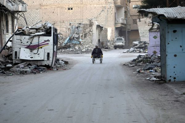 A man propels his wheelchair on February 13, 2014 in a devastated street in the Syrian eastern town of Deir Ezzor A man propels his wheelchair on February 13, 2014 in a devastated street in the Syrian eastern town of Deir Ezzor - Sputnik International