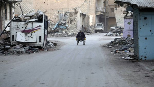 A man propels his wheelchair on February 13, 2014 in a devastated street in the Syrian eastern town of Deir Ezzor A man propels his wheelchair on February 13, 2014 in a devastated street in the Syrian eastern town of Deir Ezzor - Sputnik International