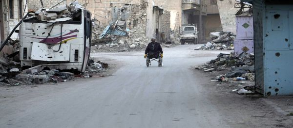 A man propels his wheelchair on February 13, 2014 in a devastated street in the Syrian eastern town of Deir Ezzor A man propels his wheelchair on February 13, 2014 in a devastated street in the Syrian eastern town of Deir Ezzor - Sputnik International
