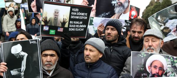 Iranian and Turkish demonstrators hold pictures of Shiite cleric Sheikh Nimr al-Nimr as they protest outside the Saudi Embassy in Ankara, on January 3, 2016, to protest against the execution by Saudi Arabia of a prominent Shiite cleric which they saw as a deliberate sectarian aggression Iranian and Turkish demonstrators hold pictures of Shiite cleric Sheikh Nimr al-Nimr as they protest outside the Saudi Embassy in Ankara, on January 3, 2016, to protest against the execution by Saudi Arabia of a prominent Shiite cleric which they saw as a deliberate sectarian aggression - Sputnik International
