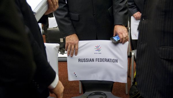 A delegate of the Russian delegation takes a seat prior to the start of a World Trade Organization ministerial meeting to give its second and final approval for Russia's membership in the trade body after a record 18-year quest to join, on December 16, 2011 in Geneva A delegate of the Russian delegation takes a seat prior to the start of a World Trade Organization ministerial meeting to give its second and final approval for Russia's membership in the trade body after a record 18-year quest to join, on December 16, 2011 in Geneva - Sputnik International