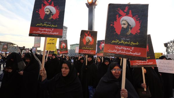 Iranian women gather during a demonstration against the execution of prominent Shiite Muslim cleric Nimr al-Nimr (portrait) by Saudi authorities, at Imam Hossein Square in the capital Tehran on January 4, 2016 Iranian women gather during a demonstration against the execution of prominent Shiite Muslim cleric Nimr al-Nimr (portrait) by Saudi authorities, at Imam Hossein Square in the capital Tehran on January 4, 2016 - Sputnik International