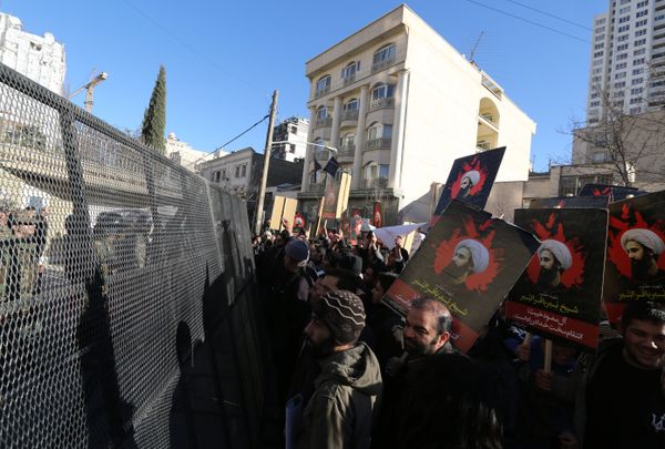 Iranian riot police block a street leading to the Saudi embassy as protesters hold portraits of prominent Shiite Muslim cleric Nimr al-Nimr during a demonstration against his execution by Saudi authorities, on January 3, 2016, in Tehran Iranian riot police block a street leading to the Saudi embassy as protesters hold portraits of prominent Shiite Muslim cleric Nimr al-Nimr during a demonstration against his execution by Saudi authorities, on January 3, 2016, in Tehran - Sputnik International