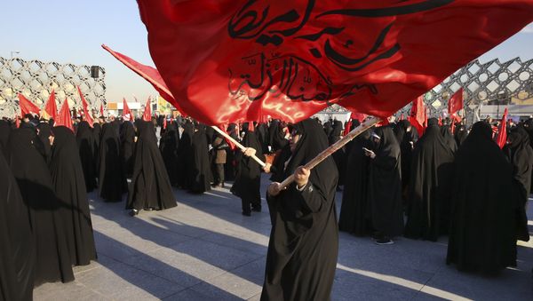 Iranian women wave flags that read, Death to America and we shall never accept humiliation, during a rally to protest the execution by Saudi Arabia last week of Sheikh Nimr al-Nimr, a prominent opposition Saudi Shiite cleric, in Tehran, Iran, Monday, Jan. 4, 2016 - Sputnik International