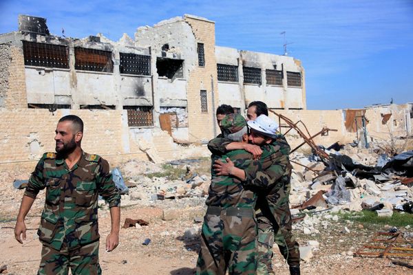Syrian government troops hug each other in celebration inside the Kuweires air base, east of Aleppo, Syria - Sputnik International