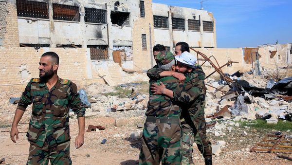 Syrian government troops hug each other in celebration inside the Kuweires air base, east of Aleppo, Syria Syrian government troops hug each other in celebration inside the Kuweires air base, east of Aleppo, Syria - Sputnik International