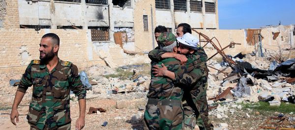 Syrian government troops hug each other in celebration inside the Kuweires air base, east of Aleppo, Syria - Sputnik International