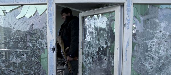 An Afghan policeman inspects a building used by insurgents after an operation near the Indian consulate in Mazar-i-Sharif, Afghanistan January 5, 2016 - Sputnik International