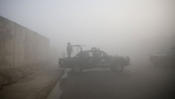 An Afghan policeman keeps watch atop a police vehicle near the site of Monday's blast near the Kabul international airport An Afghan policeman keeps watch atop a police vehicle near the site of Monday's blast near the Kabul international airport - Sputnik International