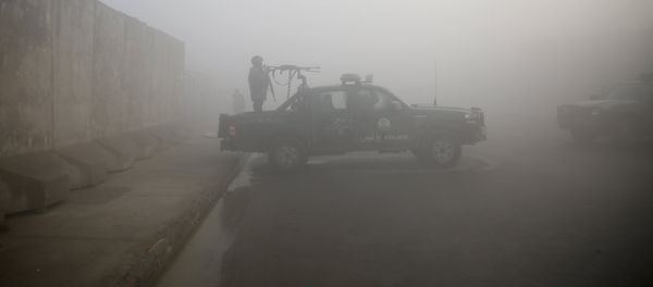 An Afghan policeman keeps watch atop a police vehicle near the site of Monday's blast near the Kabul international airport An Afghan policeman keeps watch atop a police vehicle near the site of Monday's blast near the Kabul international airport - Sputnik International
