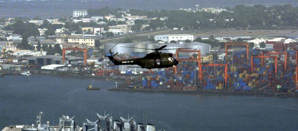 Helicopter flies over Djibouti harbour as part of city is seen, background - Sputnik International