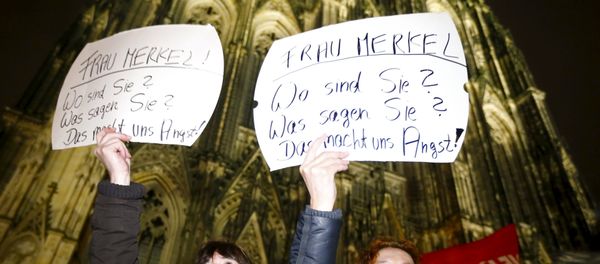 Women hold up placards that read Mrs. Merkel: Where are you? What are you saying? This worries us! during a protest in front of the Cologne Cathedral, Germany, January 5, 2016 Women hold up placards that read Mrs. Merkel: Where are you? What are you saying? This worries us! during a protest in front of the Cologne Cathedral, Germany, January 5, 2016 - Sputnik International