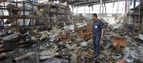 A worker stands at a beverages factory after it was hit by a Saudi-led air strike in Yemen's Red Sea port city of Houdieda January 6, 2016. - Sputnik International