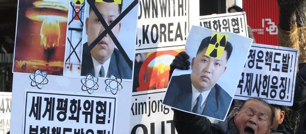 A South Korean protester with a photo of North Korean leader Kim Jong Un shouts slogans during a rally against North Korea's announcement that it had tested a hydrogen bomb. - Sputnik International