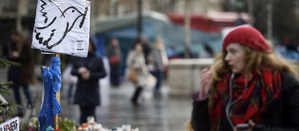 A picture taken on January 7, 2016 shows a woman standing in front of a makeshift memorial for the victims of Paris attacks at the Place de la Republique in Paris. - Sputnik International
