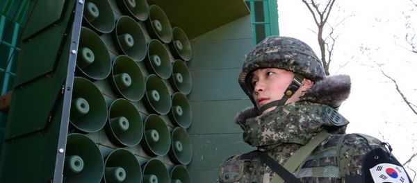 South Korean soldier stands guard in front of loudspeakers as the military prepares propaganda broadcasts near the border area between South Korea and North Korea in Yeoncheon, northeast of Seoul, on January 8, 2016 South Korean soldier stands guard in front of loudspeakers as the military prepares propaganda broadcasts near the border area between South Korea and North Korea in Yeoncheon, northeast of Seoul, on January 8, 2016 - Sputnik International