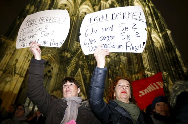 Women hold up placards that read Mrs. Merkel: Where are you? What are you saying? This worries us! during a protest in front of the Cologne Cathedral, Germany, January 5, 2016. Germans have been deeply shocked by a series of attacks, assaults, and other crimes committed by asylum-seekers taking advantage of Merkel's open-door immigration policy. - Sputnik International