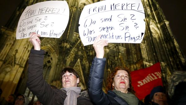 Women hold up placards that read Mrs. Merkel: Where are you? What are you saying? This worries us! during a protest in front of the Cologne Cathedral, Germany, January 5, 2016 Women hold up placards that read Mrs. Merkel: Where are you? What are you saying? This worries us! during a protest in front of the Cologne Cathedral, Germany, January 5, 2016 - Sputnik International