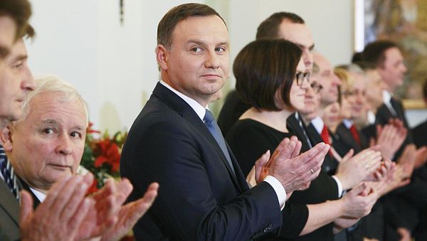 Polish President Andrzej Duda,center, and the leader of Law and Justice party Jaroslaw Kaczynski, second left, attend the Prime Minister nomination ceremony for Beata Szydlo in the Presidential Palace in Warsaw, Poland, Friday, Nov. 13, 2015 - Sputnik International