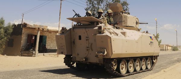 File photo, Egyptian Army soldiers patrol in an armored vehicle backed by a helicopter gunship during a sweep through villages in Sheikh Zuweyid, north Sinai, Egypt - Sputnik International