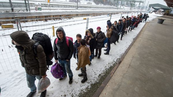 Refugees walk to a chartered train at the railway station of Passau, Germany Tuesday Jan. 5, 2016 Refugees walk to a chartered train at the railway station of Passau, Germany Tuesday Jan. 5, 2016 - Sputnik International