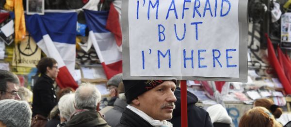 A man holding a placard reading I am afraid but I am here during a gathering on Place de la Republique (Republic square) on January 10, 2016 in Paris, as the city marks a year since 1.6 million people thronged the French capital in a show of unity after attacks on the Charlie Hebdo newspaper and a Jewish supermarket - Sputnik International