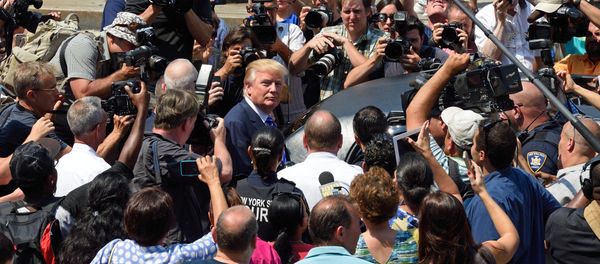 US presidential candidate Donald Trump(C) is mobbed by the media as he exits New York Supreme Court after morning jury duty August 17, 2015 in New York - Sputnik International