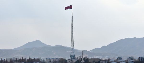 A North Korean flag flutters in the propaganda village of Gijungdong as seen from a South Korean military check point of the truce village of Panmunjom in the Demilitarized Zone dividing the two Koreas on November 12, 2014 - Sputnik International