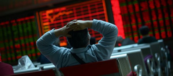 An investor looks at screens showing stock market movements at a securities company in Beijing on January 8, 2016 - Sputnik International