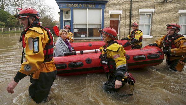 Members of emergency services rescue a woman from a flooded house in York after the river Ouse burst its banks, in northern England, in this December 28, 2015 file photo - Sputnik International