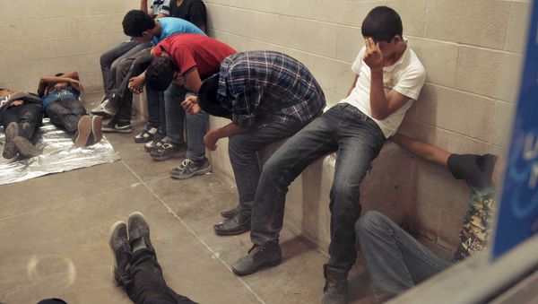 Immigrants who have been caught crossing the border illegally are housed inside the Border Patrol Station in McAllen. - Sputnik International