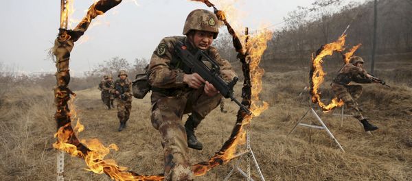 Soldiers of People's Liberation Army (PLA) Lanzhou Military Region jump through a burning obstacle during a training session at a military base in Tianshui, Gansu province, China, January 6, 2016 Soldiers of People's Liberation Army (PLA) Lanzhou Military Region jump through a burning obstacle during a training session at a military base in Tianshui, Gansu province, China, January 6, 2016 - Sputnik International