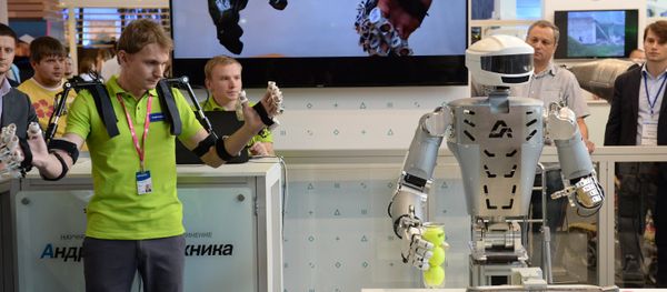 An employee of Androidnaya Teknika demonstrates a robot's operation at the V Innoprom International Industrial Exhibition in Yekaterinburg. File photo An employee of Androidnaya Teknika demonstrates a robot's operation at the V Innoprom International Industrial Exhibition in Yekaterinburg. File photo - Sputnik International