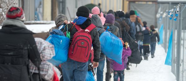 Refugees walk to a chartered train at the railway station of Passau, Germany, Jan. 5, 2016 Refugees walk to a chartered train at the railway station of Passau, Germany, Jan. 5, 2016 - Sputnik International