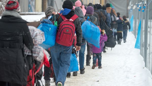 Refugees walk to a chartered train at the railway station of Passau, Germany, Jan. 5, 2016 Refugees walk to a chartered train at the railway station of Passau, Germany, Jan. 5, 2016 - Sputnik International