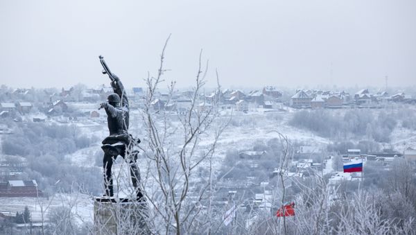 A monument to Red Army soldiers killed in action against Nazi Germany troops during World War II during the counteroffensive in 1941, at left, and Red and Russian national flags, right, are seen over houses covered with frost in the village of Peremilovo in Moscow region, Russia A monument to Red Army soldiers killed in action against Nazi Germany troops during World War II during the counteroffensive in 1941, at left, and Red and Russian national flags, right, are seen over houses covered with frost in the village of Peremilovo in Moscow region, Russia - Sputnik International