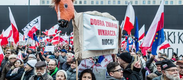 People wave European and Polish flags as they take part in a protest against a new media law in the center of Warsaw on January 9, 2016. - Sputnik International
