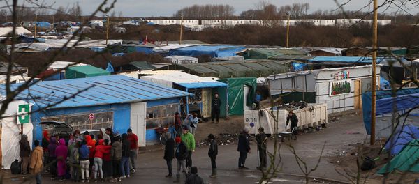 Converted containers, at rear, are placed at the entrance of the Calais refugee camp, northern France - Sputnik International