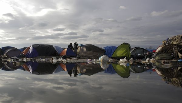In this Tuesday, Nov. 3, 2015, file photo, tents and waste are reflected in a puddle inside the migrants camp near Calais, northern France - Sputnik International