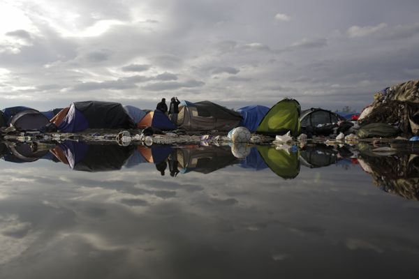 In this Tuesday, Nov. 3, 2015, file photo, tents and waste are reflected in a puddle inside the migrants camp near Calais, northern France In this Tuesday, Nov. 3, 2015, file photo, tents and waste are reflected in a puddle inside the migrants camp near Calais, northern France - Sputnik International