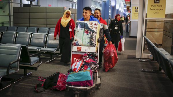 Syrian refugees arrive at the Pearson Toronto International Airport in Mississauga, Ontario Syrian refugees arrive at the Pearson Toronto International Airport in Mississauga, Ontario - Sputnik International