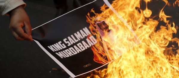 A Shi'ite Muslim burn a picture of Saudi King Salman bin Abdulaziz - Sputnik International