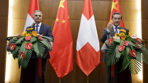 China's Foreign Minister Wang Yi (R) speaks next to Swiss Foreign Minister Didier Burkhalter at a joint news conference after a meeting at the Ministry of Foreign Affairs, in Beijing, China China's Foreign Minister Wang Yi (R) speaks next to Swiss Foreign Minister Didier Burkhalter at a joint news conference after a meeting at the Ministry of Foreign Affairs, in Beijing, China - Sputnik International