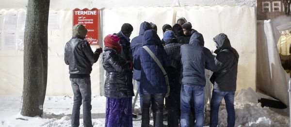 Migrants line up for an appointment in front of a waiting tent on a cold and snowy early morning, at the central registration center for refugees and asylum seekers LaGeSo (Landesamt fuer Gesundheit und Soziales - State Office for Health and Social Affairs) in Berlin - Sputnik International