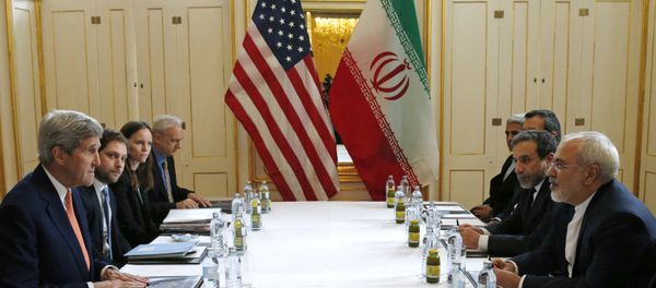 US Secretary of State John Kerry, left, meets with Iranian Foreign Minister Mohammad Javad Zarif, right, in Vienna, Austria, Saturday, Jan. 16, 2016, on what is expected to be implementation day, the day the International Atomic Energy Agency (IAEA) verifies that Iran has met all conditions under the nuclear deal. - Sputnik International
