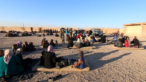 Displaced families, fleeing violence in Aleppo city and from Islamic State-controlled areas in Raqqa and Deir al-Zor, sit at a school in al-Mabroukeh village in the western countryside of Ras al-Ain, Syria December 28, 2015 Displaced families, fleeing violence in Aleppo city and from Islamic State-controlled areas in Raqqa and Deir al-Zor, sit at a school in al-Mabroukeh village in the western countryside of Ras al-Ain, Syria December 28, 2015 - Sputnik International