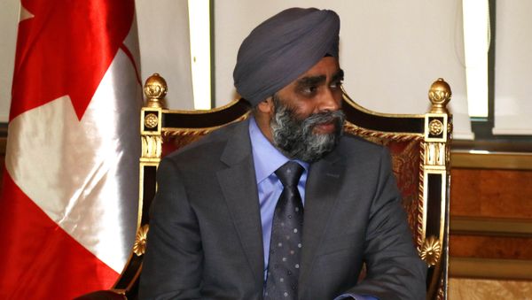 Canadian Minister of National Defence Harjit Sajjan looks on during his meeting with Iraqi Kurdish leader Massud Barzani in Arbil, the capital of the Kurdish autonomous region in northern Iraq, on December 21, 2015 - Sputnik International
