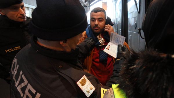 Austrian police officer check the identification documents of migrants before allowing them to get out a bus from Slovenia to cross the border from Slovenia into Austria, at a checkpoint at the Karawanks tunnel near Villach, Austria, Wednesday, Jan. 13, 2016 Austrian police officer check the identification documents of migrants before allowing them to get out a bus from Slovenia to cross the border from Slovenia into Austria, at a checkpoint at the Karawanks tunnel near Villach, Austria, Wednesday, Jan. 13, 2016 - Sputnik International